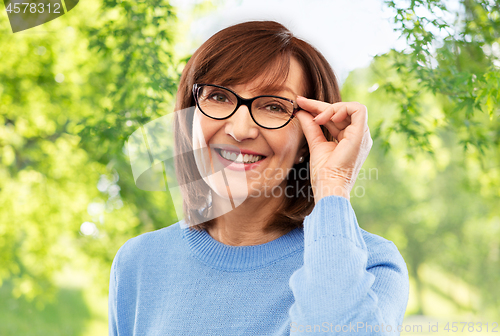 Image of portrait of senior woman in glasses over grey