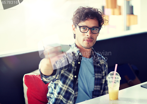 Image of happy man with cash money paying at cafe