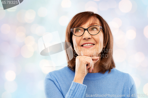 Image of portrait of senior woman in glasses dreaming