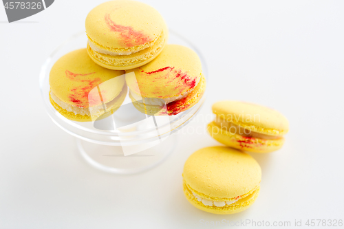 Image of close up of yellow macarons on confectionery stand