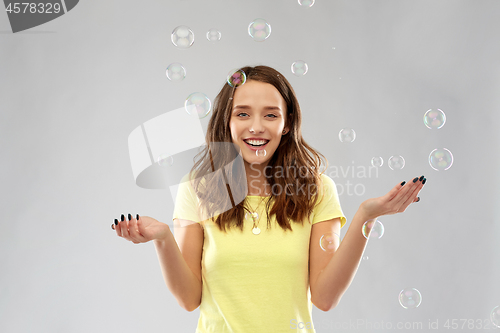 Image of young woman or teenage gir with soap bubbles