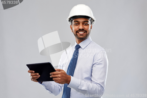 Image of architect or businessman in helmet with tablet pc