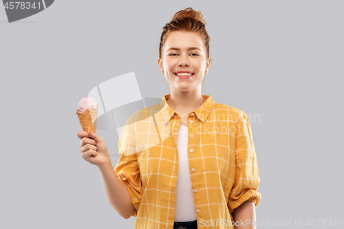 Image of happy red haired teenage girl with ice cream cone