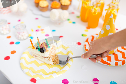 Image of hand putting piece of birthday cake on plate