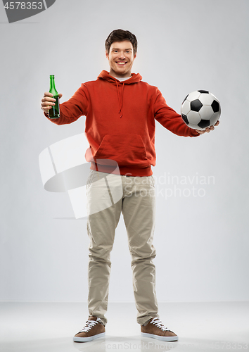 Image of man or football fan with soccer ball and beer