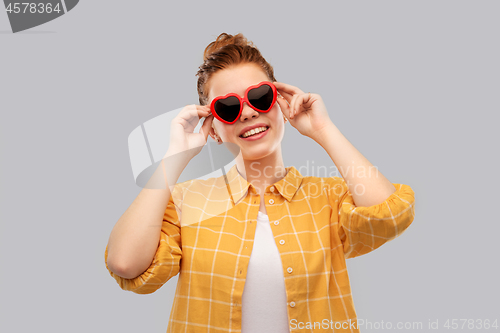 Image of red haired teenage girl in heart-shaped sunglasses