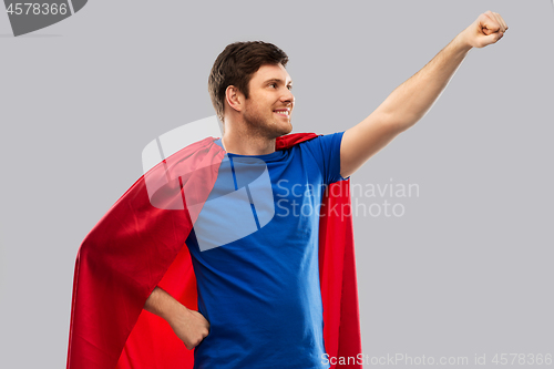 Image of man in red superhero cape over grey background