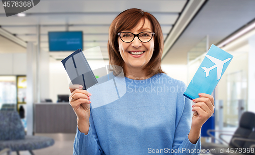 Image of senior woman with passport and airplane ticket