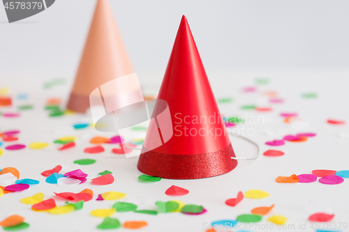 Image of red birthday party cap and confetti