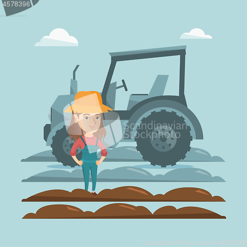 Image of Farmer standing on the background of tractor.