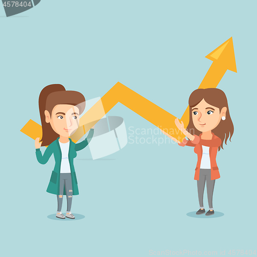 Image of Two young business women holding growth graph.