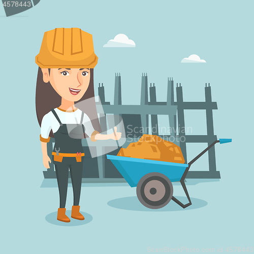 Image of Young caucasian female builder giving thumb up.