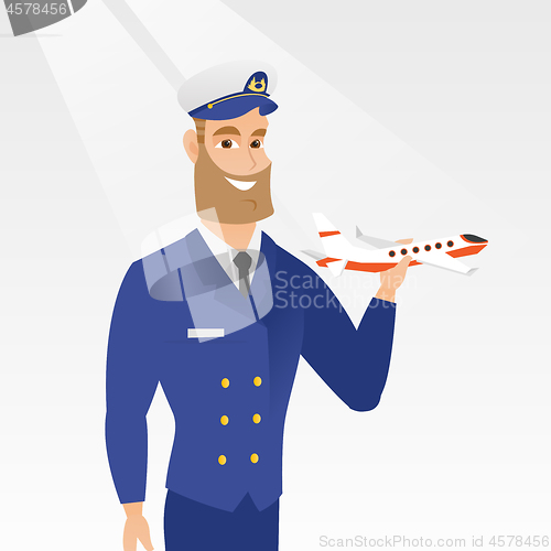 Image of Cheerful airline pilot with the model of airplane.