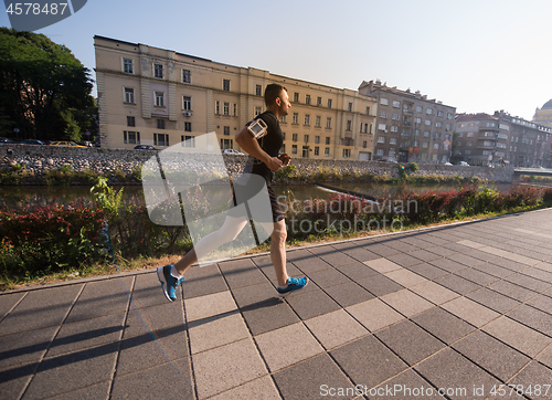 Image of man jogging at sunny morning