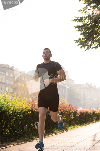 Image of man jogging at sunny morning