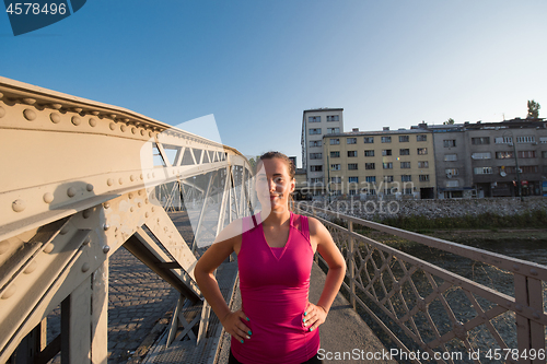 Image of portrait of a jogging woman at sunny morning