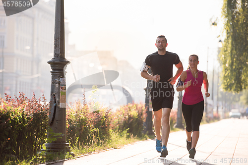 Image of young couple jogging  in the city