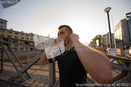 Image of portrait of a jogging man at sunny morning