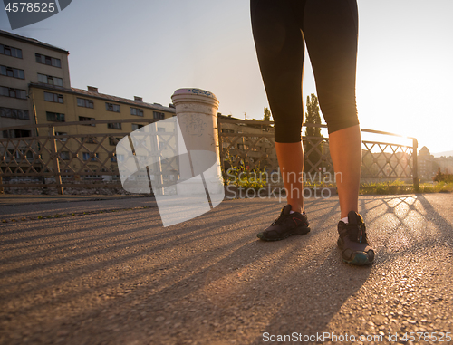 Image of portrait of a jogging woman at sunny morning