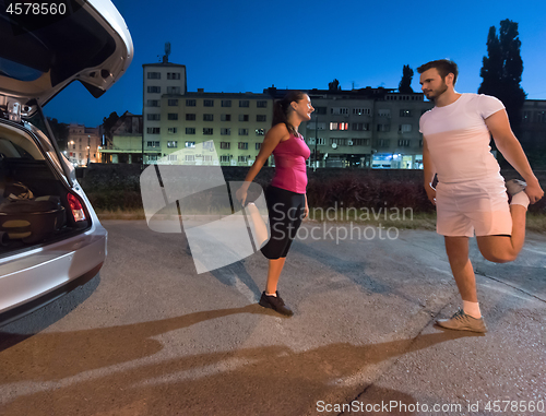 Image of couple warming up and stretching