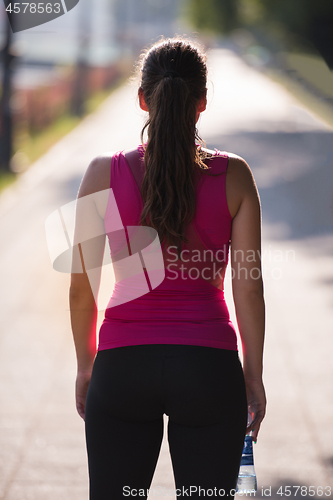 Image of woman jogging at sunny morning