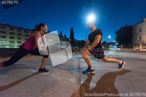 Image of couple warming up and stretching