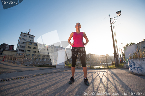 Image of portrait of a jogging woman at sunny morning