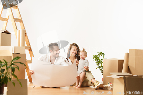 Image of Couple moving to a new home - Happy married people buy a new apartment to start new life together