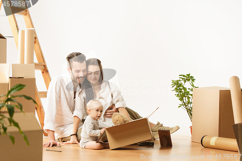 Image of Couple moving to a new home - Happy married people buy a new apartment to start new life together