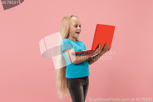 Image of The happy child with red laptop on pink