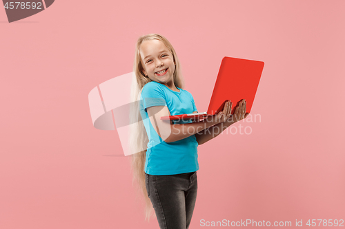 Image of The happy child with red laptop on pink