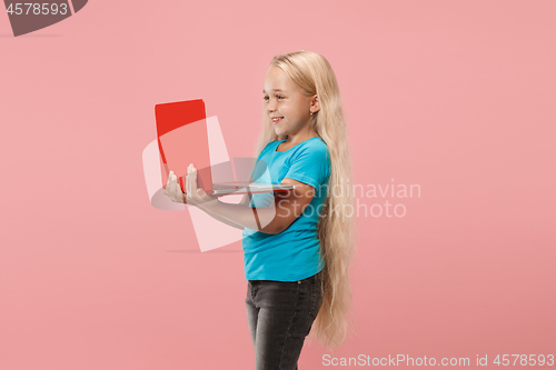 Image of The happy child with red laptop on pink