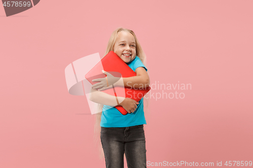 Image of The happy child with red laptop on pink