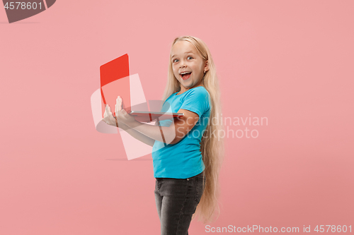 Image of The happy child with red laptop on pink