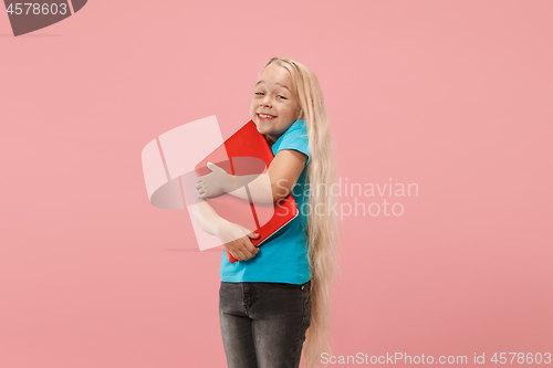 Image of The happy child with red laptop on pink