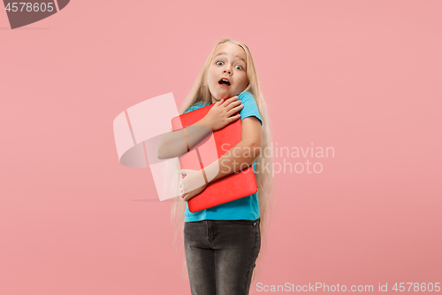 Image of The happy child with red laptop on pink