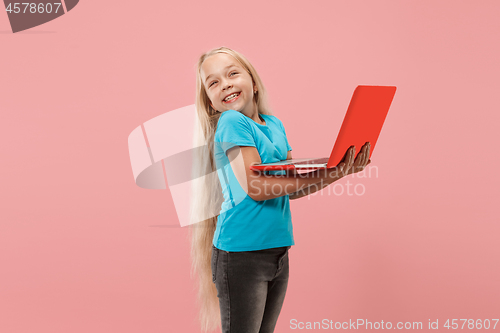 Image of The happy child with red laptop on pink