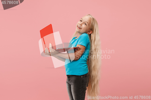 Image of The happy child with red laptop on pink