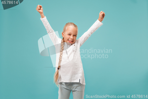 Image of Happy success teen girl celebrating being a winner. Dynamic energetic image of female model