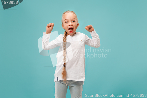 Image of Happy success teen girl celebrating being a winner. Dynamic energetic image of female model