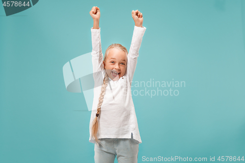 Image of Happy success teen girl celebrating being a winner. Dynamic energetic image of female model