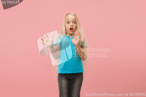 Image of Portrait of the scared girl on pink