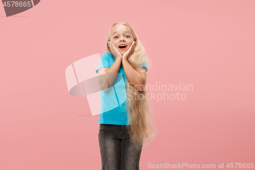 Image of Beautiful teen girl looking suprised isolated on pink