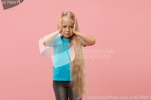 Image of Girl having headache. Isolated over pink background.