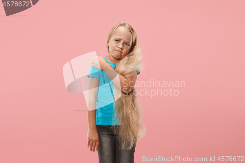 Image of Young girl overwhelmed with a pain in the shoulder