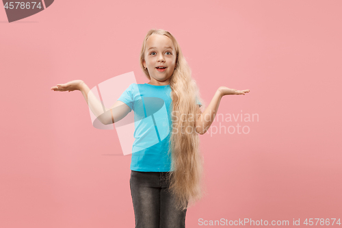 Image of Beautiful teen girl looking suprised isolated on pink