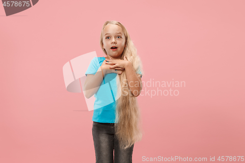 Image of Beautiful teen girl looking suprised isolated on pink