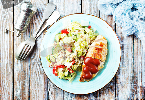 Image of fried chicken breast and salad