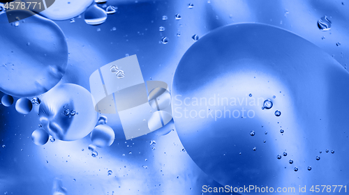 Image of Defocused abstract background picture made with oil, water and soap. Blue toned.