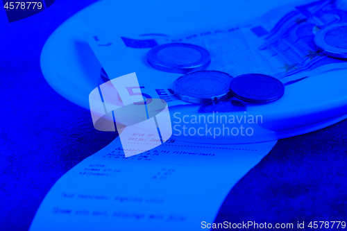 Image of Tip on a restaurant table. Blue toned.